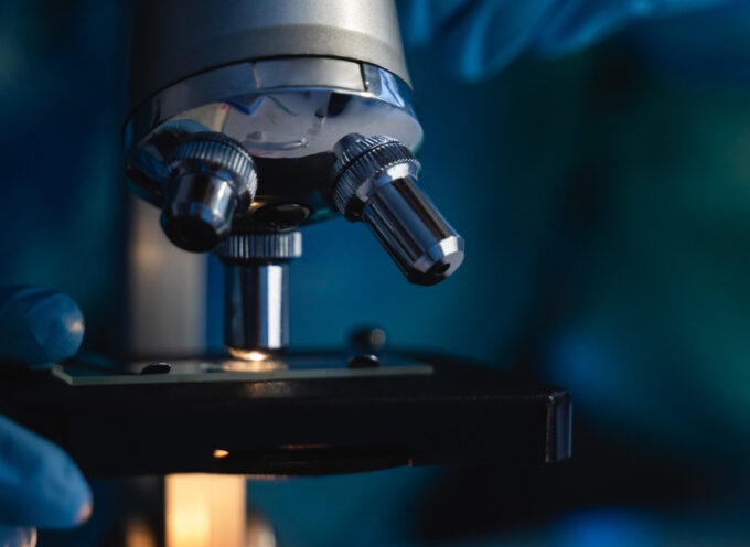 Close up of scientist hands working on microscope inside laboratory - Vaccine against coronavirus concept -Focus on optics